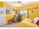 Bright bedroom featuring a sunny yellow color scheme and comfortable furnishings at 4331 E Redwood Ln, Phoenix, AZ 85048