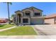 Two story home featuring desert landscaping, neutral color palette, and a two car garage at 4331 E Redwood Ln, Phoenix, AZ 85048
