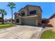 This two story home features desert landscaping, mature palm trees and two-car garage at 4331 E Redwood Ln, Phoenix, AZ 85048