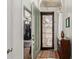 Inviting foyer with an ornamental iron entry door and a view into a home gym at 4331 E Redwood Ln, Phoenix, AZ 85048