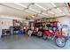 Spacious garage with ample storage shelving, two dirt bikes, and an automatic door at 4331 E Redwood Ln, Phoenix, AZ 85048