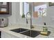 Close up of a modern sink with updated faucet and white marble countertops and backsplash at 4331 E Redwood Ln, Phoenix, AZ 85048