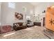 Bright living room with high ceilings, neutral walls, tiled floors, and comfortable leather sofa at 4331 E Redwood Ln, Phoenix, AZ 85048