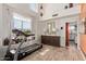 Well-lit living room with tiled floors, decorous light fixture and a treadmill in a window nook at 4331 E Redwood Ln, Phoenix, AZ 85048