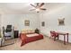 A carpeted primary bedroom is bright with natural light, featuring a ceiling fan at 4331 E Redwood Ln, Phoenix, AZ 85048