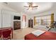 A carpeted primary bedroom is bright with natural light, featuring a ceiling fan at 4331 E Redwood Ln, Phoenix, AZ 85048