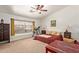 A carpeted primary bedroom is bright with natural light, featuring a ceiling fan at 4331 E Redwood Ln, Phoenix, AZ 85048