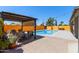 Inviting pool area with a shade pergola and privacy landscaping for relaxation and entertainment at 4331 E Redwood Ln, Phoenix, AZ 85048