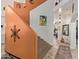 Close-up of the staircase with terra-cotta walls, tile flooring and artistic wall decor at 4331 E Redwood Ln, Phoenix, AZ 85048