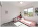 Sunlit bedroom with a twin bed, comfortable seating and a window view, creating a cozy atmosphere at 4562 S Park Grove St # 101, Gilbert, AZ 85297