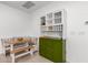 Cozy dining area with built-in bench seating and a stylish cabinet for storage and display at 4562 S Park Grove St # 101, Gilbert, AZ 85297