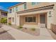 Charming townhome featuring a stone facade, covered entryway, and well-maintained desert landscaping at 4562 S Park Grove St # 101, Gilbert, AZ 85297