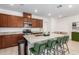 Modern kitchen featuring a large island with bar seating, stainless steel appliances, and granite countertops at 4562 S Park Grove St # 101, Gilbert, AZ 85297