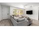 Bright living room with a large window, comfortable seating, and modern tile flooring at 4562 S Park Grove St # 101, Gilbert, AZ 85297