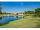 Scenic pond with a fountain and lush green landscape, surrounded by beautiful homes and serene nature at 4562 S Park Grove St # 101, Gilbert, AZ 85297