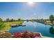 Picturesque pond with a wooden pier and vibrant flowers, perfect for enjoying waterfront views and activities at 4562 S Park Grove St # 101, Gilbert, AZ 85297