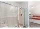 Modern bathroom showcasing a glass-enclosed shower with a built-in seat and a view into the bedroom at 4562 S Park Grove St # 101, Gilbert, AZ 85297