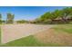 Well-maintained sand volleyball court surrounded by lush greenery, perfect for outdoor recreational activities at 4562 S Park Grove St # 101, Gilbert, AZ 85297