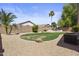 Backyard featuring a grass area, desert landscaping, and privacy wall at 4566 E La Costa Dr, Chandler, AZ 85249