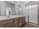 Bathroom featuring vanity with double sinks and a glass door shower at 4566 E La Costa Dr, Chandler, AZ 85249