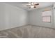 Neutral bedroom featuring a ceiling fan, carpet flooring, and a bright window at 4566 E La Costa Dr, Chandler, AZ 85249