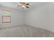 Bright bedroom featuring a ceiling fan, carpet flooring, and a bright window at 4566 E La Costa Dr, Chandler, AZ 85249
