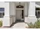 This covered front entryway boasts a light-colored front door and attractive architectural details at 4566 E La Costa Dr, Chandler, AZ 85249