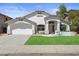 This exterior home view offers a manicured lawn, lush plantings and covered entry at 4566 E La Costa Dr, Chandler, AZ 85249