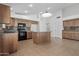 Bright kitchen with tile floor, center island, stainless appliances and backsplash at 4566 E La Costa Dr, Chandler, AZ 85249