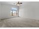Spacious living room with vaulted ceilings, carpet, and big window at 4566 E La Costa Dr, Chandler, AZ 85249