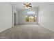 Spacious living room with vaulted ceilings, large windows, and carpet at 4566 E La Costa Dr, Chandler, AZ 85249