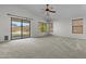 Carpeted living room with ceiling fan and backyard access at 4566 E La Costa Dr, Chandler, AZ 85249