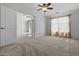 Carpeted main bedroom with ceiling fan and access to the bathroom at 4566 E La Costa Dr, Chandler, AZ 85249