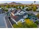 Expansive aerial view of a modern two story home with a dark roof and black trim amid lush landscaping at 4813 E Earll Dr, Phoenix, AZ 85018