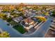 Wide aerial shot exhibits landscaping, neighborhood and surrounding palms trees near the property at 4813 E Earll Dr, Phoenix, AZ 85018