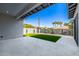 A view of the backyard that features green grass, decorative rock, a patio, and a block wall for added privacy at 4813 E Earll Dr, Phoenix, AZ 85018