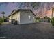 A view of the home's exterior from the backyard that features decorative rock and a block wall at 4813 E Earll Dr, Phoenix, AZ 85018