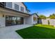 A view of the backyard that features green grass, decorative rock, a patio, and sliding glass doors to the home at 4813 E Earll Dr, Phoenix, AZ 85018