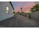 A view of the home's exterior from the backyard that features decorative rock and a block wall at 4813 E Earll Dr, Phoenix, AZ 85018