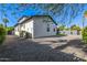 Back of house view shows rock landscaping and a white house with dark framed windows at 4813 E Earll Dr, Phoenix, AZ 85018