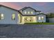 A view of the home's exterior that features green grass, decorative rock, a patio, and sliding glass doors to the home at 4813 E Earll Dr, Phoenix, AZ 85018