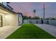 View of backyard with green grass, custom landscaping, and a privacy fence for added seclusion at 4813 E Earll Dr, Phoenix, AZ 85018