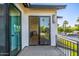 Balcony featuring light wood floors, mountain views, black railing, and an open patio with a sliding glass door at 4813 E Earll Dr, Phoenix, AZ 85018