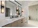 Modern bathroom with a dual sink vanity, quartz countertops, and black hardware at 4813 E Earll Dr, Phoenix, AZ 85018