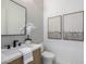 Modern powder bathroom with gray tile wall, and floating vanity at 4813 E Earll Dr, Phoenix, AZ 85018