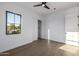Clean bedroom features light hardwood floors, white walls, black-trimmed window and closet with sliding door at 4813 E Earll Dr, Phoenix, AZ 85018