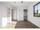 Bright bedroom with hardwood floors, closet, and exterior view at 4813 E Earll Dr, Phoenix, AZ 85018