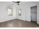 Comfortable bedroom features light hardwood floors, white walls, black-trimmed windows, and closet with sliding doors at 4813 E Earll Dr, Phoenix, AZ 85018