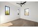 Bright bedroom with hardwood floors, ceiling fan, and multiple windows at 4813 E Earll Dr, Phoenix, AZ 85018