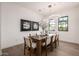 Bright dining room with modern light fixture and views to the outside at 4813 E Earll Dr, Phoenix, AZ 85018